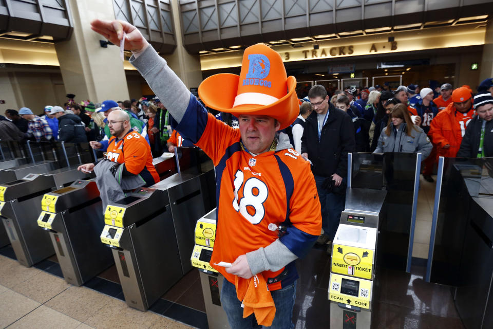 Football fans enter the Secaucus Junction, Sunday, Feb. 2, 2014, in Secaucus, N.J. The Seattle Seahawks are scheduled to play the Denver Broncos in the NFL Super Bowl XLVIII football game on Sunday evening at MetLife Stadium in East Rutherford, N.J. (AP Photo/Matt Rourke)