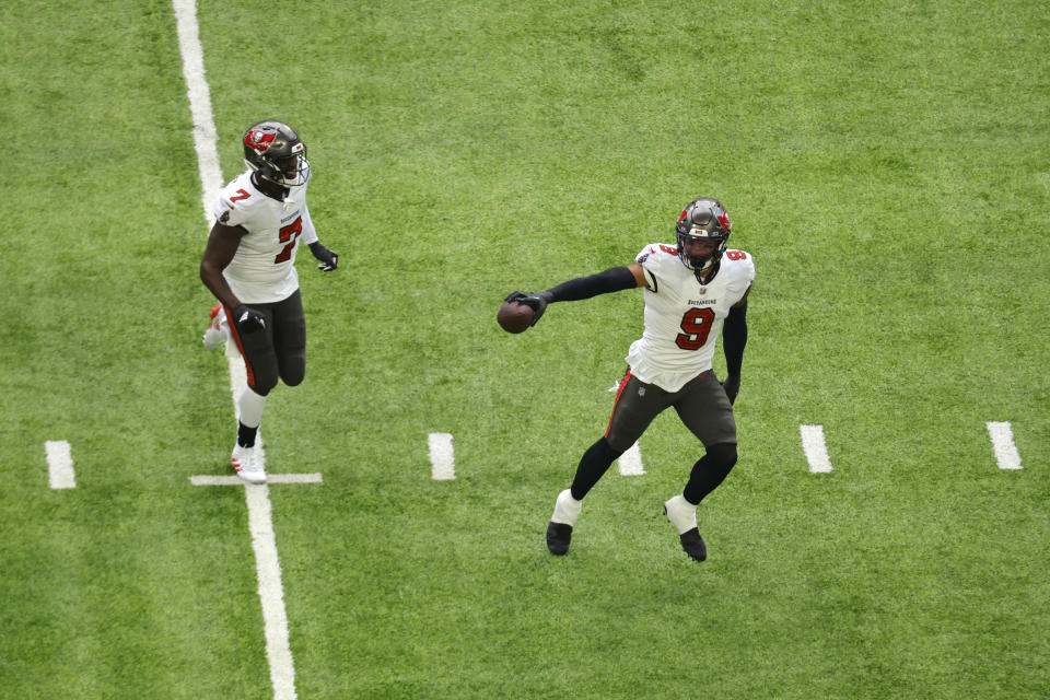 Tampa Bay Buccaneers linebacker Joe Tryon-Shoyinka (9) celebrates with teammate linebacker Shaquil Barrett (7) after recovering a fumble during the first half of an NFL football game against the Minnesota Vikings, Sunday, Sept. 10, 2023, in Minneapolis. (AP Photo/Bruce Kluckhohn)