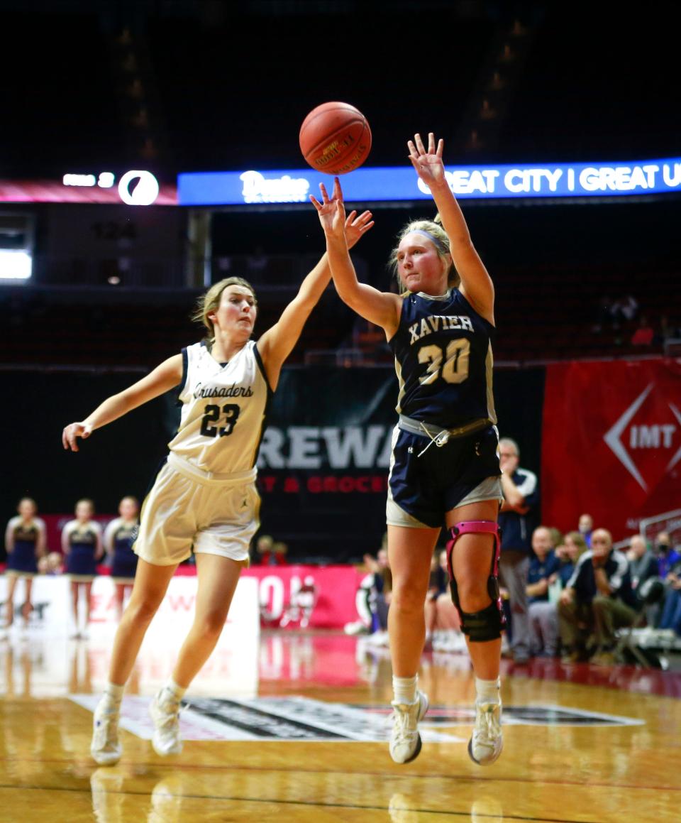 Cedar Rapids Xavier's Mary Kate Moeder fires a three-pointer against Bishop Heelan during the Class 4A girls state basketball championship game at Wells Fargo Arena in Des Moines on Saturday, March 5, 2022.