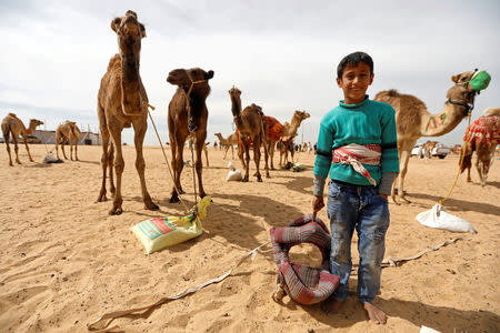 Abd El Rahman, an 8-year-old jockey, looks on during the opening of 18th International Camel Racing festival at the Sarabium desert in Ismailia, Egypt, March 12, 2019. Picture taken March 12, 2019. REUTERS/Amr Abdallah Dalsh