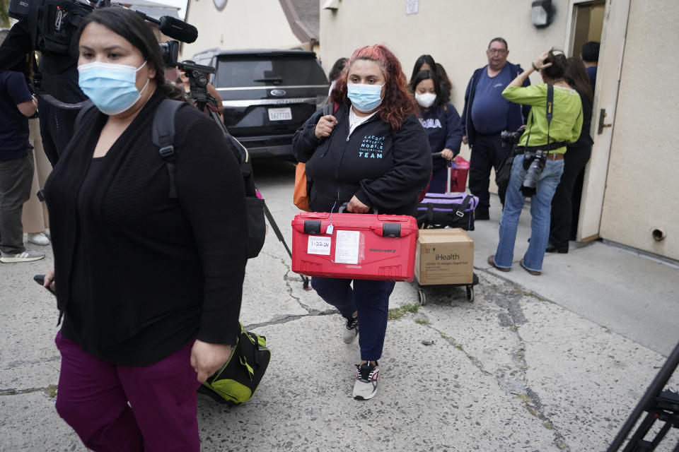 Los Angeles County Public Health Emergency Operations officials leave St. Anthony's Croatian Catholic Church after evaluating the newly arrived migrants being housed in Los Angeles on Wednesday, June 14, 2023. Forty-two people, including some children, were dropped off at Union Station around 4 p.m. Wednesday and were being cared for at the church. Texas Gov. Greg Abbott said the migrants were sent to Los Angeles because California had declared itself a "sanctuary" for immigrants. (AP Photo/Damian Dovarganes)