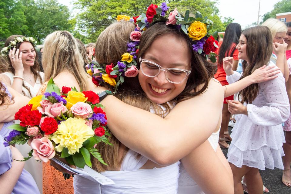 Willa Regal hugs Carissa Dunham, on May 25, 2022, on Mary's Day at the front lawn of Villa Maria Academy in Millcreek Township. In keeping with the century-long tradition, alumni gathered outside of the  Villa Maria Academy to sing the alma mater as the class of 2022 departed the school for the last time.