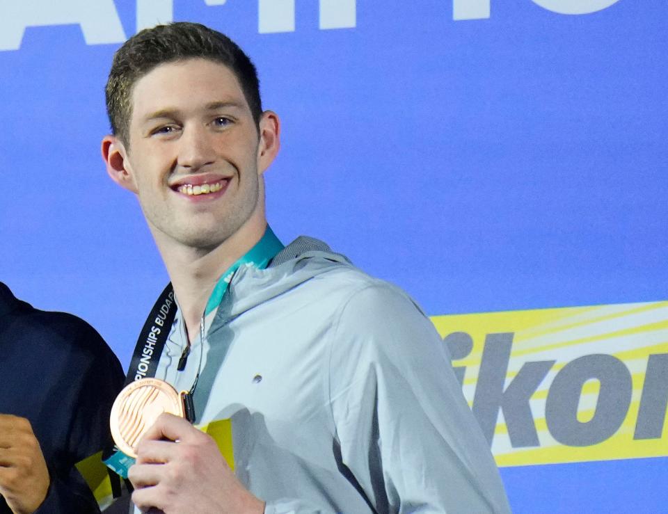 Hunter Armstrong of the United States poses with his bronze medal after the men's 100-meter backstroke final at the 19th FINA World Championships in Budapest, Hungary, Monday, June 20, 2022.