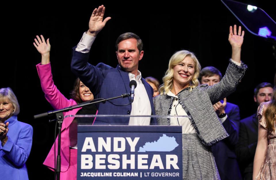 Gov. Andy Beshear waves with wife Britainy Beshear, right, and Lt. Gov. Jacqueline Coleman, at left, after winning a second term as Kentucky's governor on Tuesday, Nov.7, 2023.