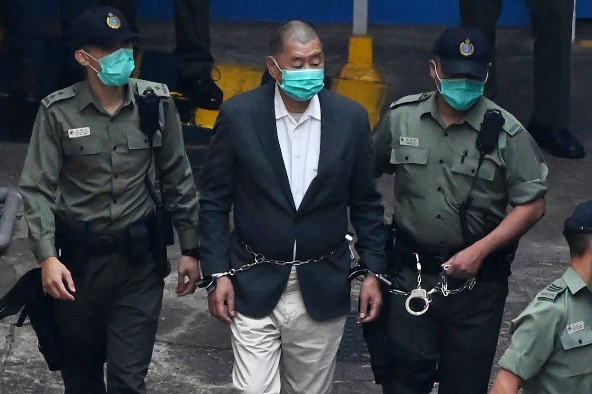 Jimmy Lai is led into a police van as he heads to court (Getty)