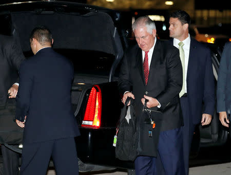 U.S. Secretary of State Rex Tillerson gathers his things to board his plane to depart for a several day Mideast trip, Friday, Oct. 20, 2017, in Andrews Air Force Base, Md. REUTERS/Alex Brandon/Pool