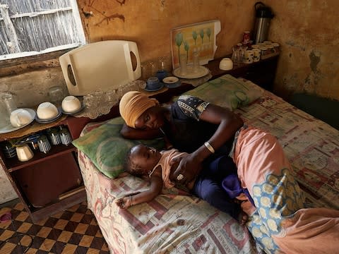 Marie, 15, with her 10-month-old baby Aminata - Credit: Francesco Brembati