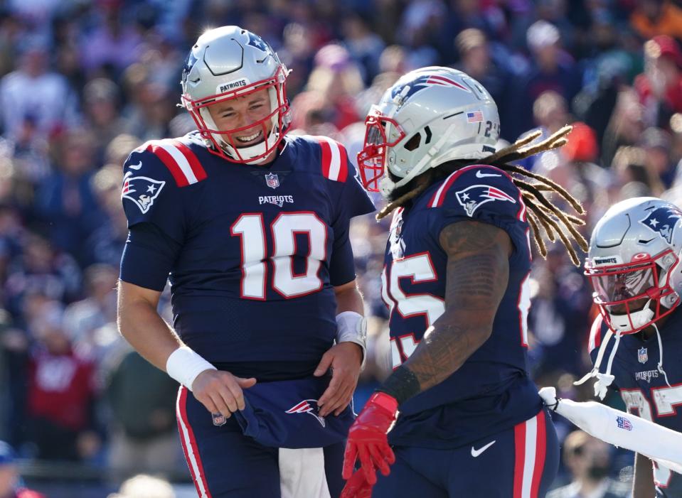 Patriots quarterback Mac Jones celebrates with teammates after a touchdown against the Jets in the second quarter.