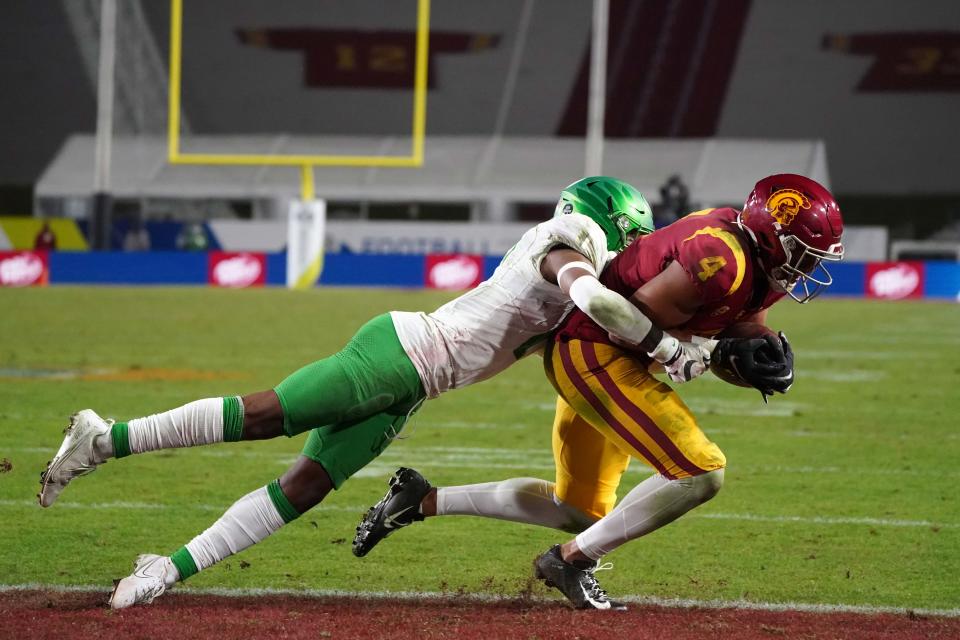 Dec 18, 2020; Los Angeles, California, USA; Southern California Trojans wide receiver Bru McCoy (4) is defended by Oregon Ducks cornerback Mykael Wright (2) on a 4-yard touchdown reception in the fourth quarter during the Pac-12 Championship at United Airlines Field at Los Angeles Memorial Coliseum. Oregon defeated USC 31-24.