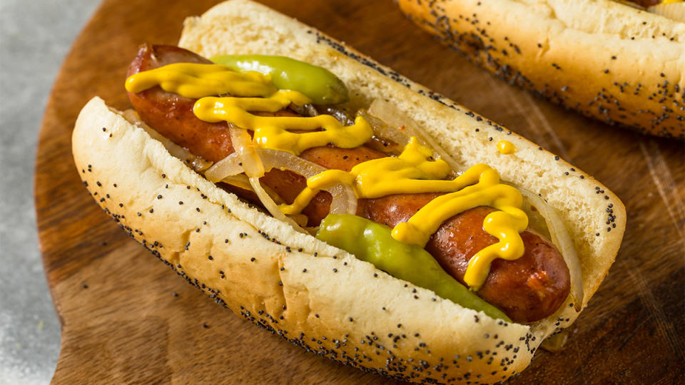 Kielbasa sausage that was cooked in the air fryer being served in a bun with condiments