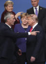 NATO Secretary General Jens Stoltenberg, left, speaks with U.S. President Donald Trump, right, after a group photo at a NATO leaders meeting at The Grove hotel and resort in Watford, Hertfordshire, England, Wednesday, Dec. 4, 2019. NATO Secretary-General Jens Stoltenberg rejected Wednesday French criticism that the military alliance is suffering from brain death, and insisted that the organization is adapting to modern challenges. (AP Photo/Francisco Seco)