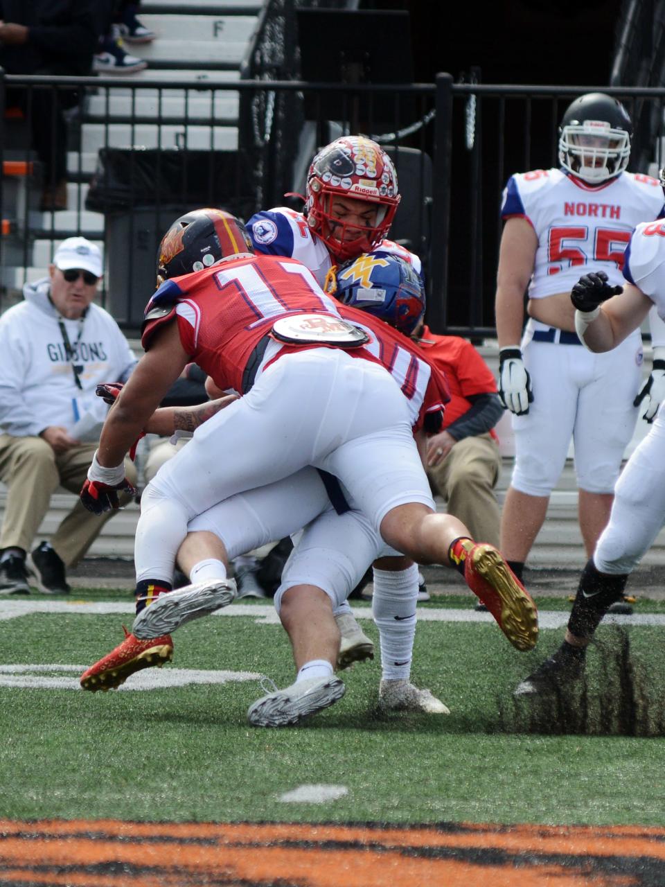 West Muskingum's Harley Hopkins, of the South squad, makes a tackle on Leavittsburg Labrae's Aidan Stephens during the annual Ohio North-South All-Star Football Classic on Saturday at Paul Brown Tiger Stadium in Massillon.