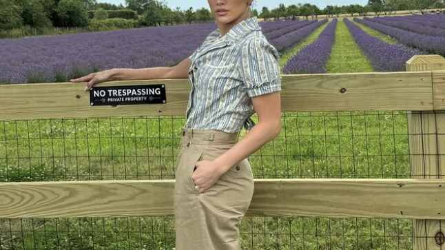 a person standing in front of a field of flowers