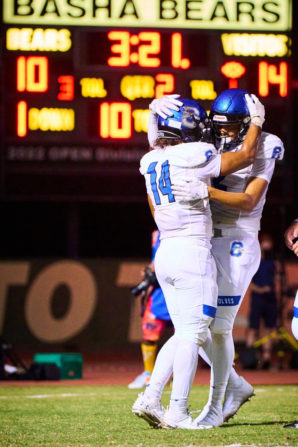 Chandler Wolves wide receivers Carter Ochoa (14) and Justice Spann (2) embrace each other after Ochoa completed a pass into the touchdown against the Basha Bears at Basha High School in Chandler on Oct. 20, 2023.