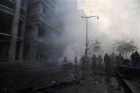 Fire fighting and army personnel inspect the site of an explosion in Beirut's downtown area December 27, 2013. REUTERS/Steve Crisp