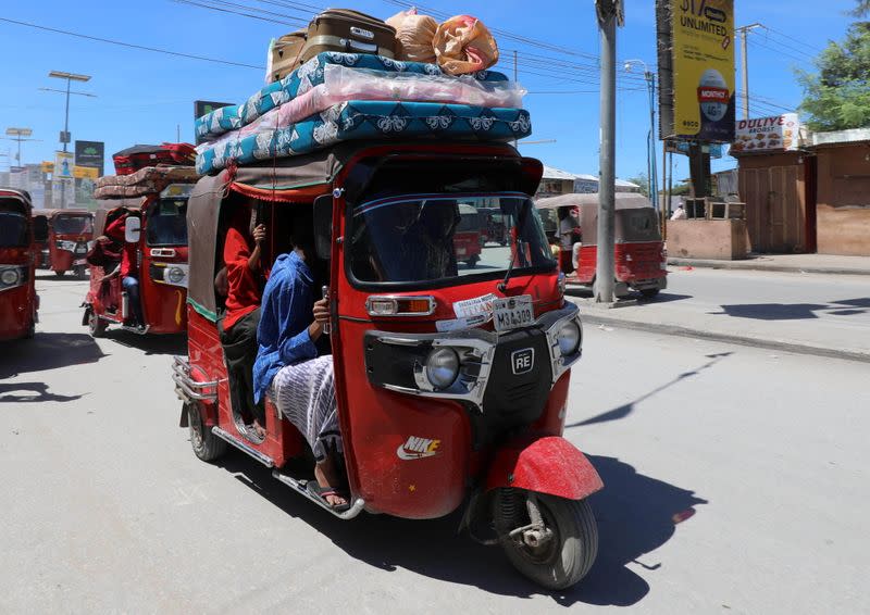 Residents ride in rickshaws as they flee, in Hodan district of Mogadishu