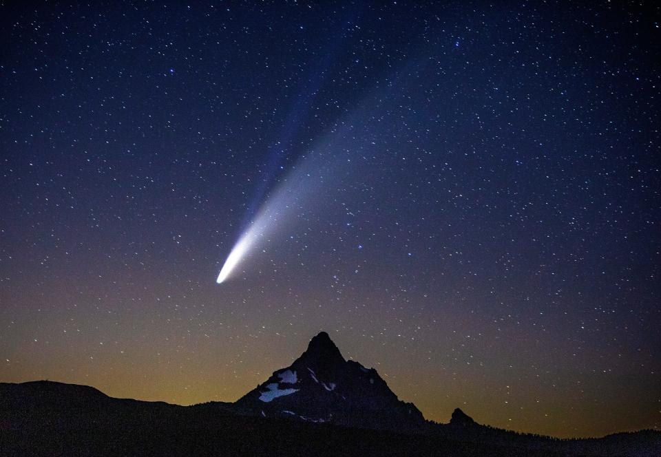Comet Neowise hangs in the sky over Mount Washington as seen from Dee Wright Observatory in the Oregon Cascades in July 2020.