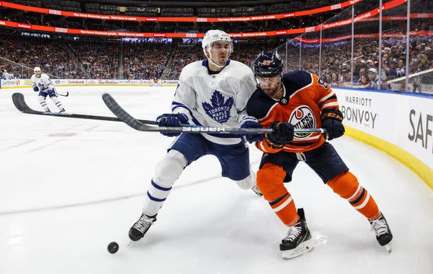 Toronto Maple Leafs' Justin Holl (3) and Edmonton Oilers' Sam Gagner (89) battle for the puck during an NHL game in Edmonton, Alta., on Dec. 14, 2019.