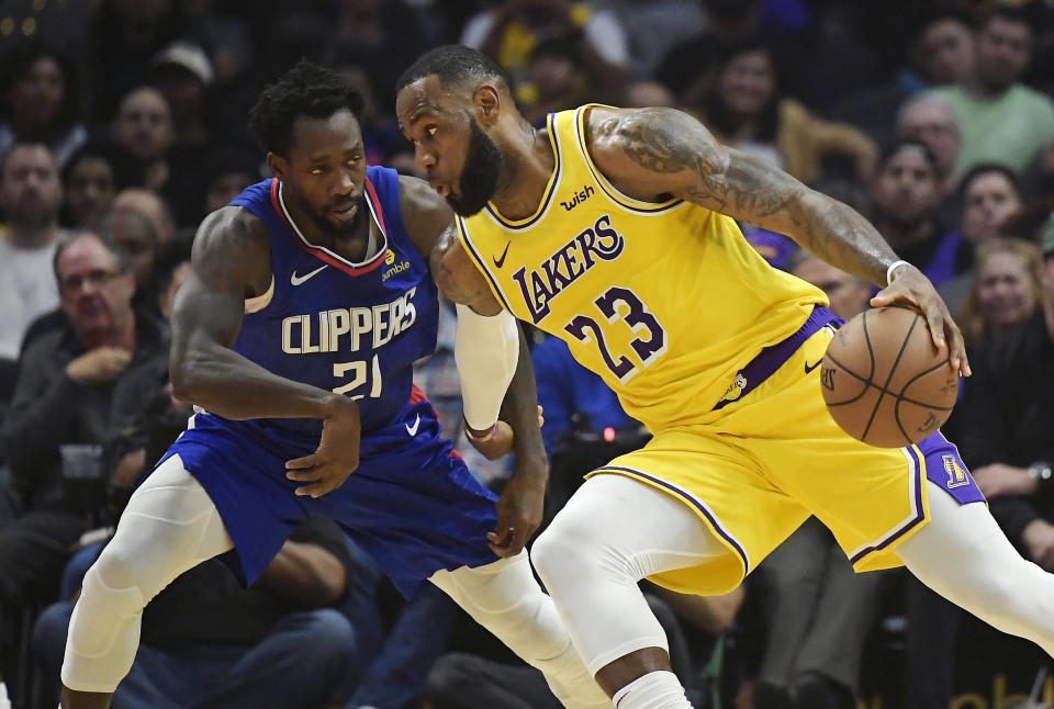 Los Angeles Lakers forward LeBron James, right, tries to drive past Los Angeles Clippers guard Patrick Beverley during the first half of an NBA basketball game Thursday, Jan. 31, 2019, in Los Angeles. (AP Photo/Mark J. Terrill)