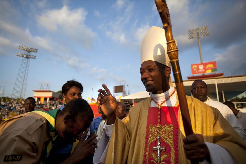 Newly-appointed Cardinal Chibly Langlois blesses a man as he leads a Mass in Port-au-Prince, Haiti, Sunday, March 9, 2014. Langlois is Haiti's first cardinal. In his new role, he has led negotiations among political parties to figure out how to hold legislative and local elections that are overdue. (AP Photo/Dieu Nalio Chery)