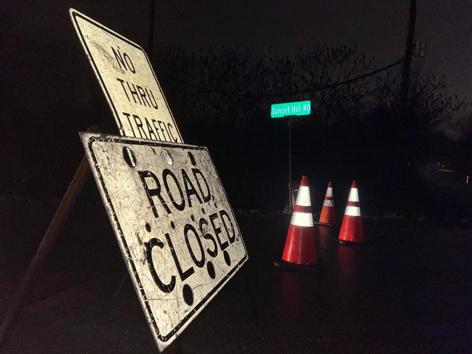 Road closure signs and cones block off the intersection of Old Creamery and Sunset Hill roads in Williston due to high waters washing out the soil beneath the pavement on Dec. 18, 2023.