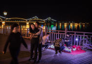 <p>A Chinese couple embrace as they stand near the “Friendship Bridge”, left, and “Broken Bridge”, right, next to the Yalu river near the border city of Dandong, Liaoning province, northern China towards the city of Sinuiju, North Korea on May 24, 2017 in Dandong, China. (Photo: Kevin Frayer/Getty Images) </p>