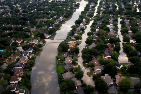 FILE PHOTO: Houses are seen partially submerged in flood waters caused by Tropical Storm Harvey in Northwest Houston, Texas, U.S., August 30, 2017.REUTERS/Adrees Latif/File Photo