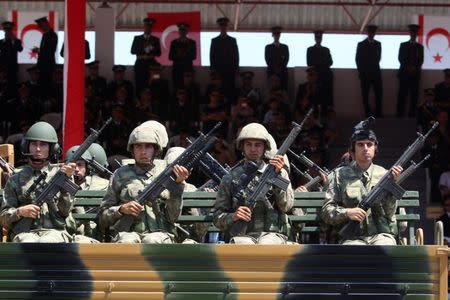 Turkish soldiers take part in a parade to mark the 1974 Turkish invasion of Cyprus in response to a briefly lived Greek-inspired coup, in the Turkish-administered northern part of Nicosia, Cyprus July 20, 2017. REUTERS/Yiannis Kourtoglou