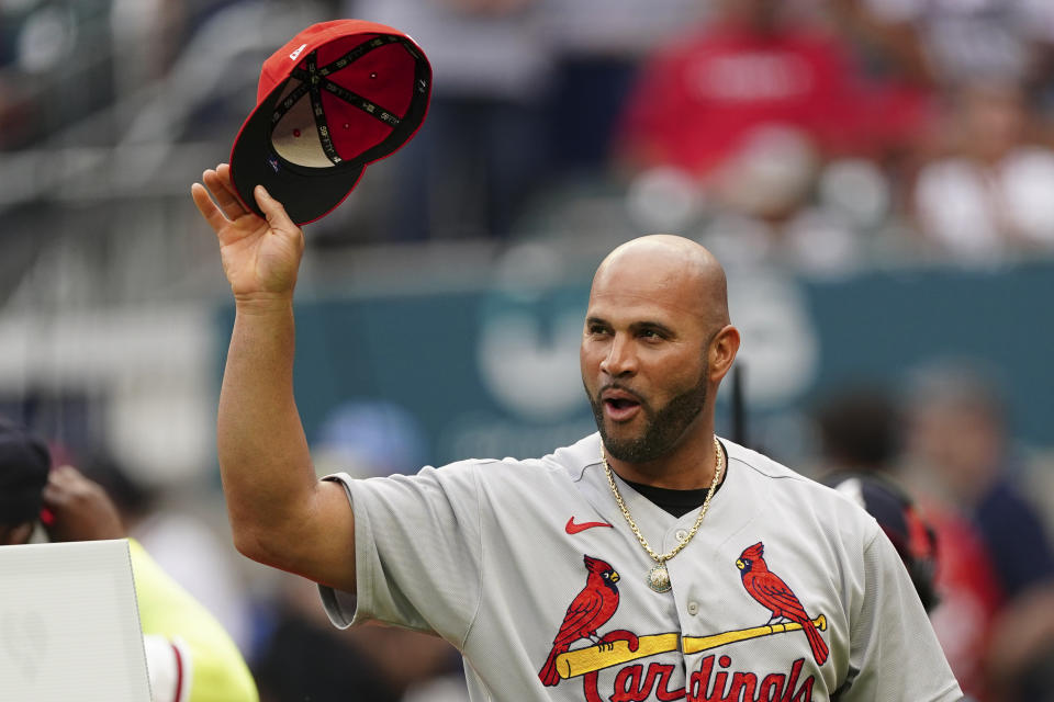 St. Louis Cardinals' Albert Pujols tips this cap to the crowd as he his honored before the team's baseball game against the Atlanta Braves on Thursday, July 7, 2022, in Atlanta. (AP Photo/John Bazemore)