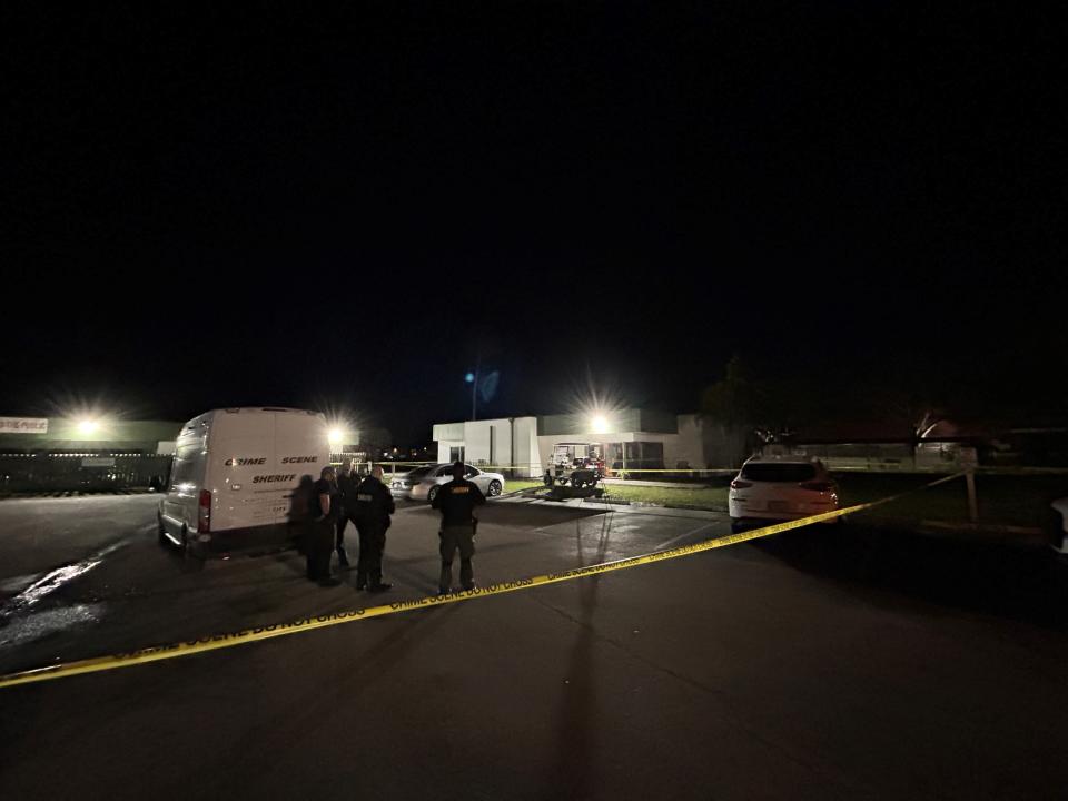 Gathered in the parking lot area of American Golf Club at 100 Woodland Drive, Indian River County Sheriff's Office crime scene investigators can be seen working outside an office area late into Monday, Feb. 19, 2024, following a fatal shooting that evening.