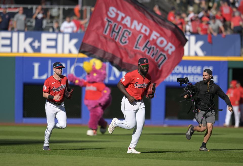 Guardians outfielders Lane Thomas (left) and Jhonkensy Noel jog off the field after defeating the Tigers in Game 1 of the ALDS, Oct. 5, 2024, in Cleveland.