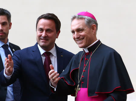 Archbishop Georg Ganswein greets Luxembourg's Prime Minister Xavier Bettel as he arrives for a meeting with Pope Francis at the Vatican March 24, 2017. REUTERS/Alessandro Bianchi