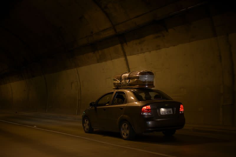 A couple transports an empty coffin to collect the body of a relative as Ecuador's government announced on Thursday it was building a "special camp" in Guayaquil for coronavirus disease (COVID-19) victims, in Guayaquil