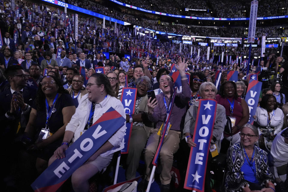 Delegates watch as former President Barack Obama speaks during the Democratic National Convention Tuesday, Aug. 20, 2024, in Chicago. (AP Photo/Brynn Anderson)