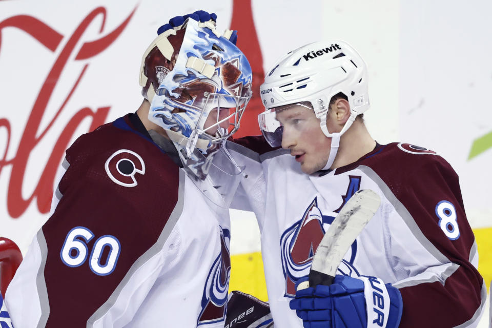 Colorado Avalanche goalie Justus Annunen celebrates with Cale Makar after the team's win over the Calgary Flames in an NHL hockey game Tuesday, March 12, 2024, in Calgary, Alberta. (Larry MacDougal/The Canadian Press via AP)