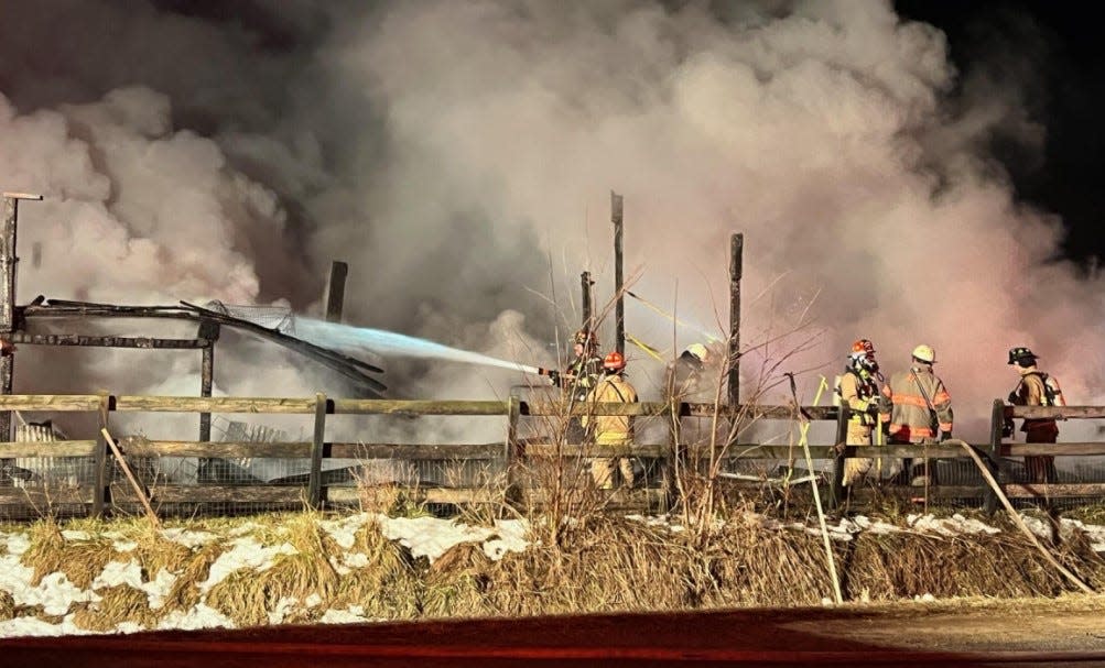 Firefighters battle a blaze in Wright Township early Wednesday, Feb. 8, 2023.