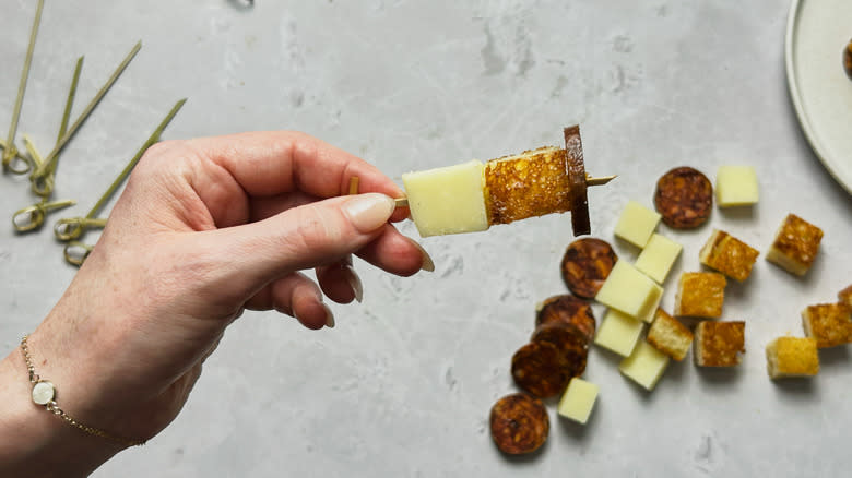 cheese, bread, and meat on skewer