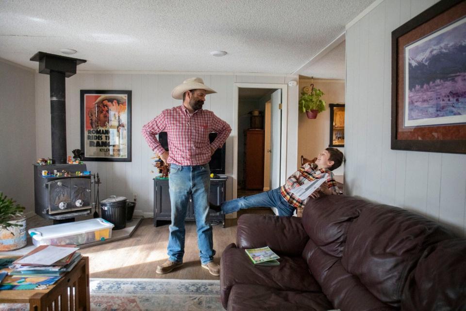 Kyler Brown and his son Elijah Brown go over the schedule for the day on June 21, 2022, before Kyler heads to the cattle drive.