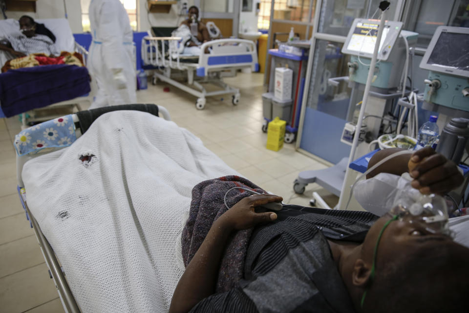 A coronavirus patient lies in the intensive care unit of an isolation and treatment center for those with COVID-19 in Machakos, south of the capital Nairobi, in Kenya Tuesday, Nov. 3, 2020. As Africa is poised to surpass 2 million confirmed coronavirus cases it is Kenya's turn to worry the continent with a second surge in infections well under way. (AP Photo/Brian Inganga)