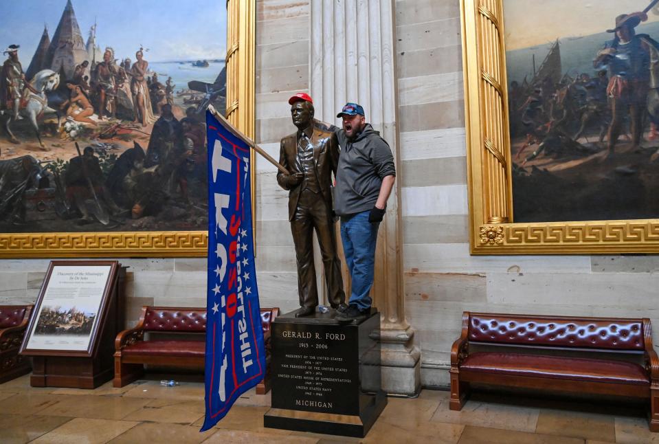 A pro-Trump rioter poses inside the Rotunda of the U.S. Capitol Building on Jan. 6, 2021. Supporters of President Trump breeched security and entered the Capitol during a special joint session of Congress to certify the Electoral College results of the 2020 election. (Saul Loeb/AFP via Getty Images)