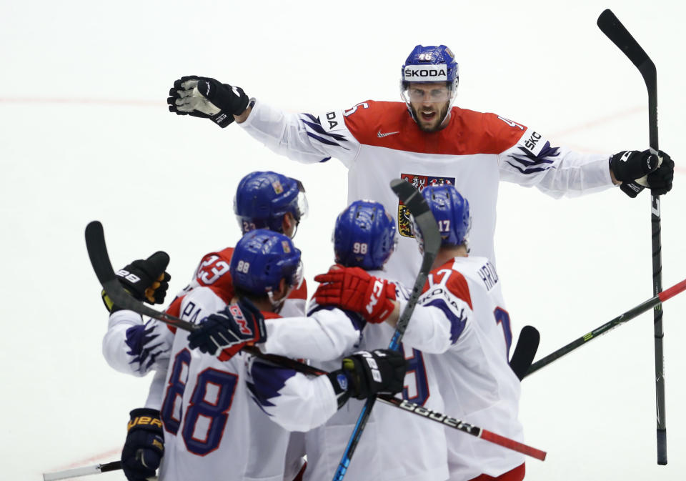 FILE- Czech Republic's David Krejci, back, and teammates celebrate a goal during the Ice Hockey World Championships quarterfinal match between the United States and Czech Republic at the Jyske Bank Boxen arena in Herning, Denmark, Thursday, May 17, 2018. Former Boston Bruins center David Krejci will lead the Czech hockey team at the forthcoming Winter Olympics at Beijing 2022. (AP Photo/Petr David Josek, File)