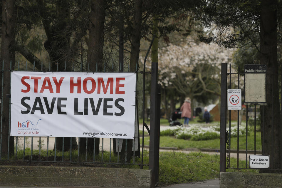 A large sign at the entrance to a park asking people top stay at home to help stop the spread of the coronavirus in London, Wednesday, April 1, 2020. The new coronavirus causes mild or moderate symptoms for most people, but for some, especially older adults and people with existing health problems, it can cause more severe illness or death.(AP Photo/Kirsty Wigglesworth)