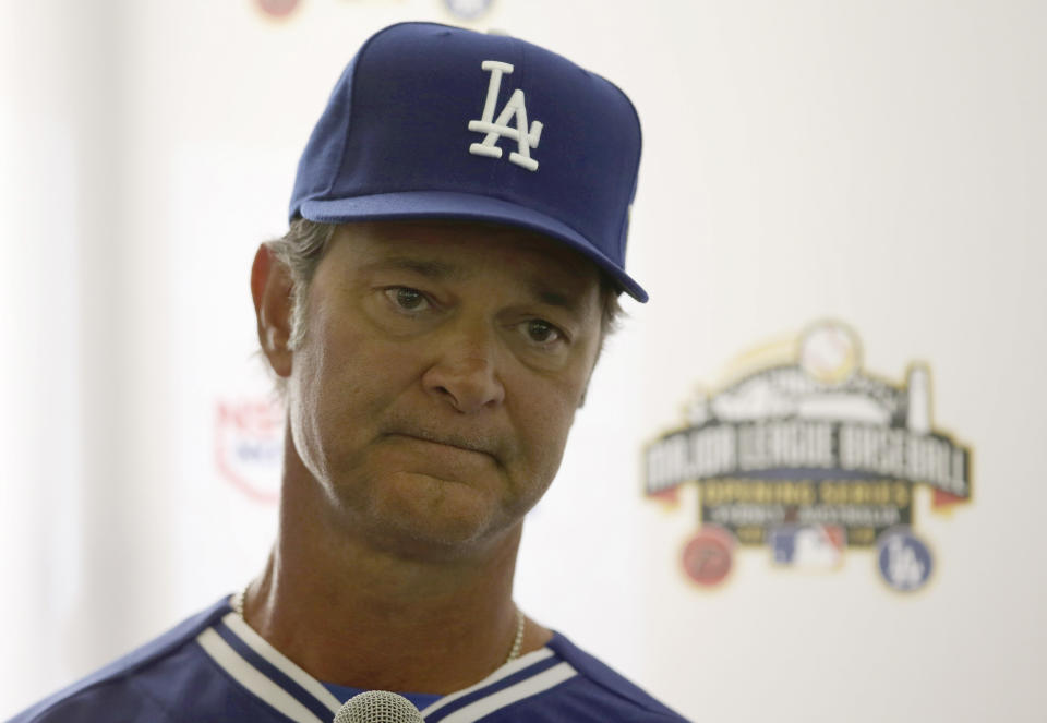 The Los Angeles Dodgers' manager Don Mattingly listens to a question during a press conference at the Sydney Cricket Ground in Sydney Tuesday, March 18, 2014. The MLB season-opening two-game series between the Los Angeles Dodgers and Arizona Diamondbacks in Sydney will be played this weekend. (AP Photo/Rick Rycroft)