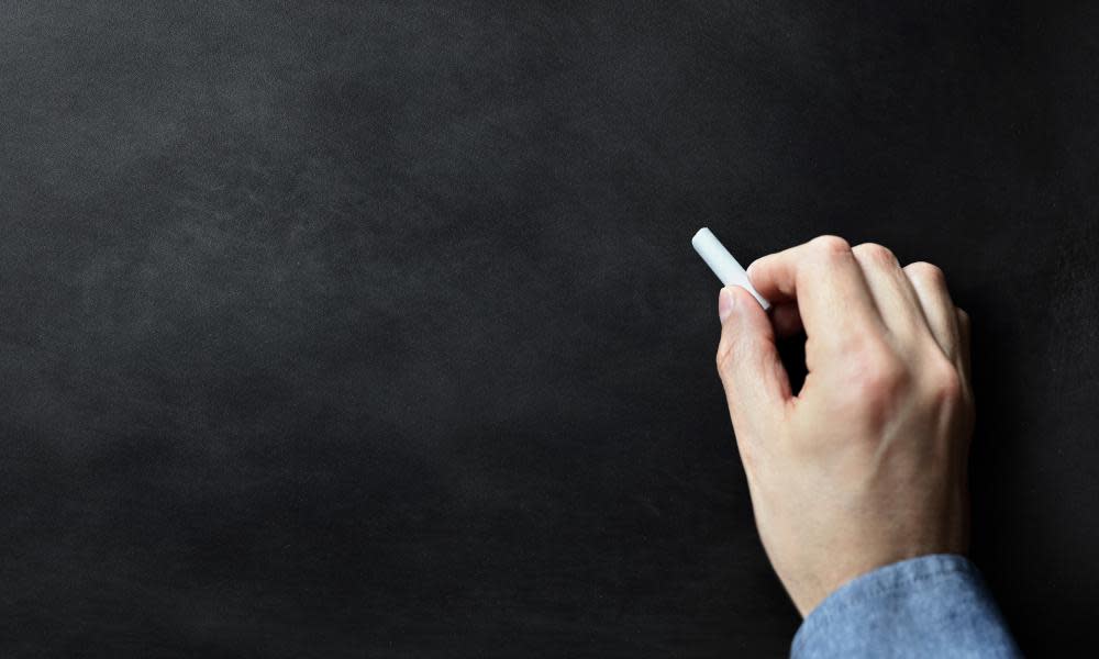 Person about to write on blackboard