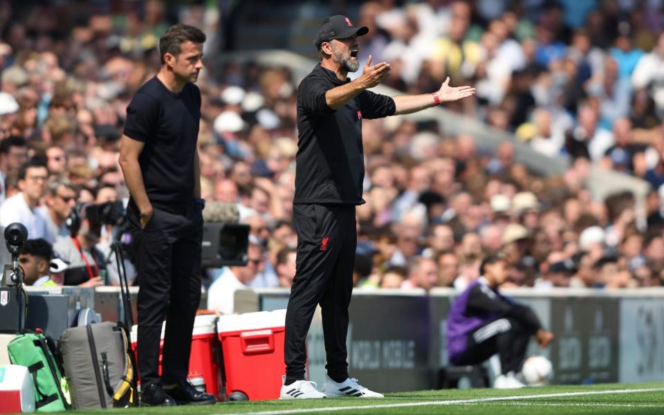 Fulham's head coach Marco Silva, left, and Liverpool's manager Jurgen Klopp follow the English Premier League soccer match - AP