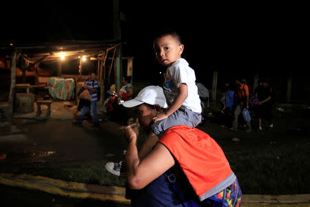 Hondurans take part in a new caravan of migrants, set to head to the United States, as they leave San Pedro Sula, Honduras January 14, 2019. REUTERS/Jorge Cabrera