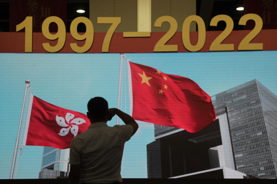 A man tours an exhibition to mark the 25th anniversary of the former British colony's return to Chinese rule, in Hong Kong, Friday, June 24, 2022. Hong Kong authorities, citing "security reasons," have barred more than 10 journalists from covering events and ceremonies this week marking the 25th anniversary of Hong Kong's return to China, according to the Hong Kong Journalists Association. (AP Photo/Kin Cheung)