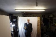 Walter Simons holds a picture of his son Eugene as he poses for a photograph in Bryansford, County Down November 10, 2014. REUTERS/Cathal McNaughton