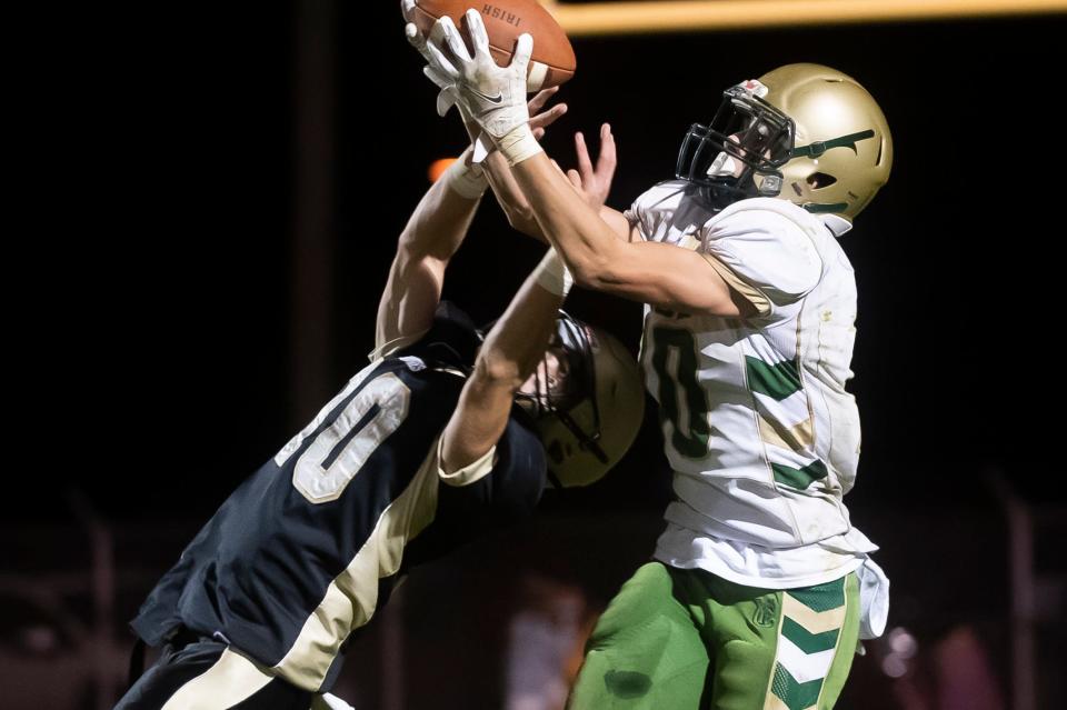 York Catholic topped Delone, 13-6, to win the YAIAA Division III title last season. Here, York Catholic's Quinn Brennan makes the catch over Delone Catholic's Ryder Noel during that game.
