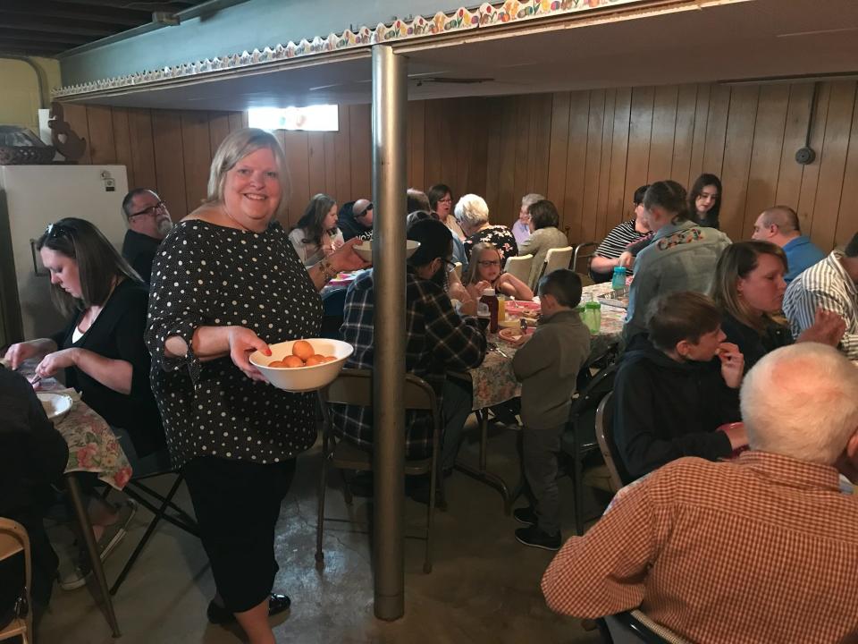 Nancy Koeckenberg serves soft-boiled eggs to her family in her Greenfield basement during the family's annual Easter breakfast.